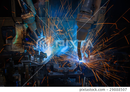 Robots are welding assembly part in factory Robots are welding assembly part in factory 29888507