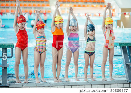 Instructor and group of children doing exercises Instructor and group of children doing exercises 29889577