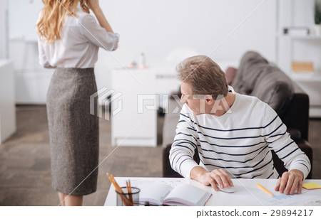 Playful aged businessman looking at young 29894217