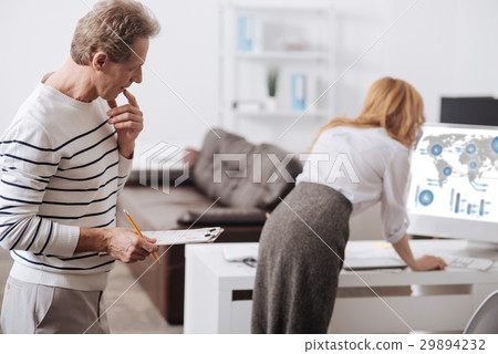 Freaky aged manager looking at young coworker back 29894232