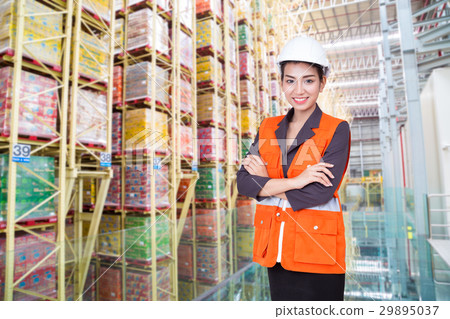 Business woman smiling in warehouse of factory Business woman smiling in warehouse of factory 29895037
