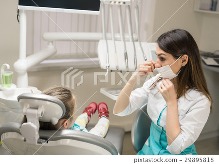 Dentist woman preparing little girl patient Dentist woman preparing little girl patient 29895818