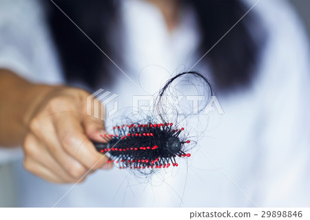 woman and hair fall in hairbrush soft focus woman and hair fall in hairbrush soft focus 29898846
