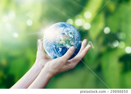 Hands holding and protecting earth on nature 29898850