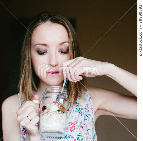 Girl eating muesli out of Cup Girl eating muesli out of Cup 29899893