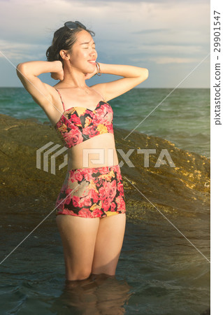 Girl enjoying seaside sunset view 29901547