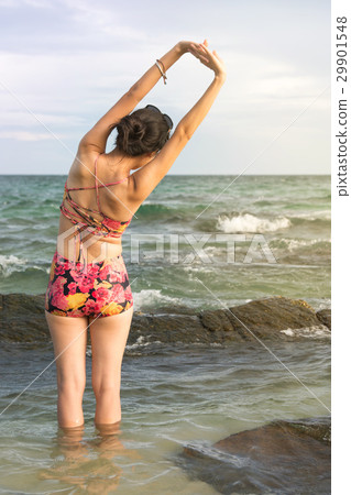 Girl stretching at the seaside Girl stretching at the seaside 29901548