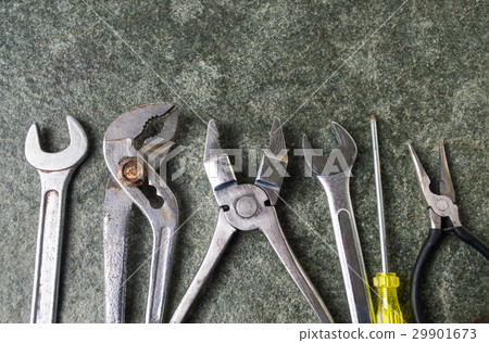 Old metal tools on a stone table Old metal tools on a stone table 29901673
