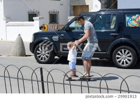 The father learns his son riding on skateboard 29901913