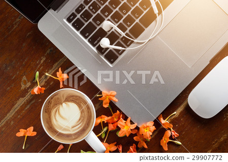 Laptop, earphone and flowers with coffee cup 29907772