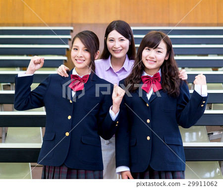 Smile teacher and high school student who poses guts in the classroom 29911062