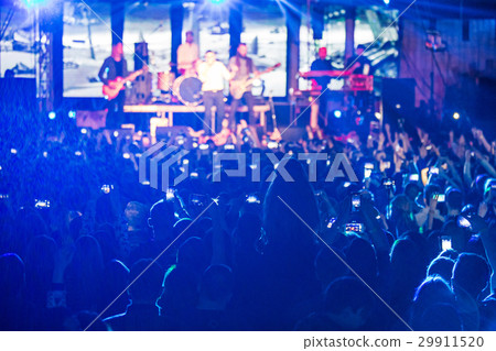 The silhouettes of concert crowd in front of 29911520