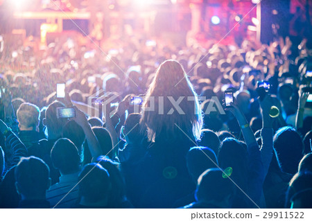The silhouettes of concert crowd in front of 29911522