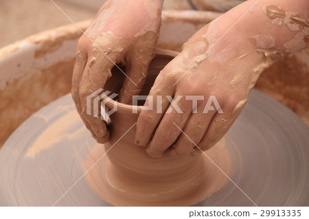 Hands of a potter, creating an earthen jar on Hands of a potter, creating an earthen jar on 29913335