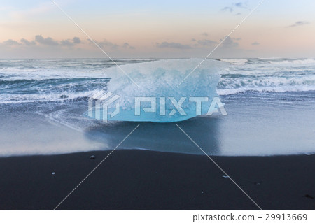 Ice breaking on black sand beach ocean skyline Ice breaking on black sand beach ocean skyline 29913669