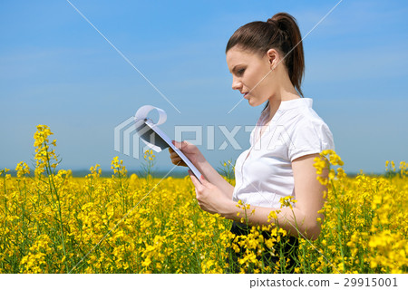 Business woman in field outdoor with cloudy sky Business woman in field outdoor with cloudy sky 29915001