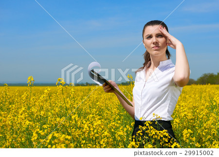 Business woman in field outdoor with cloudy sky Business woman in field outdoor with cloudy sky 29915002