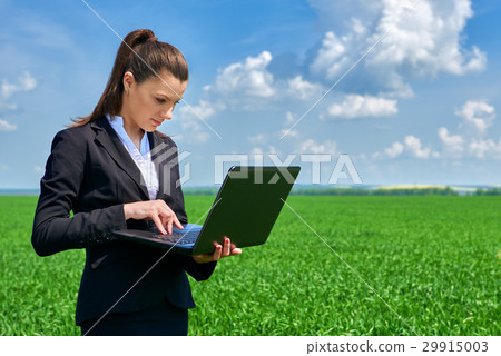 Business woman in field outdoor with cloudy sky 29915003