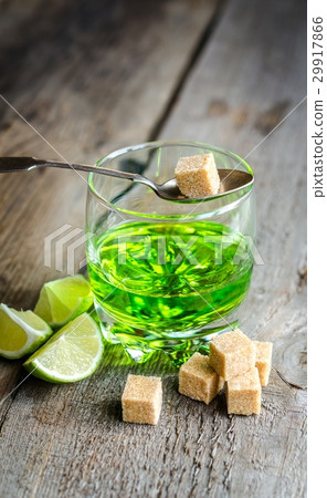 Glass of absinthe with lime and sugar cubes 29917866