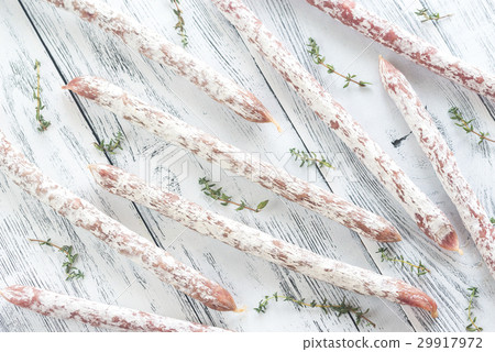 Fuet sausages on the wooden background 29917972