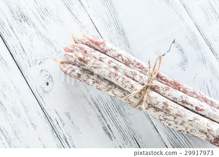 Fuet sausages on the wooden background 29917973