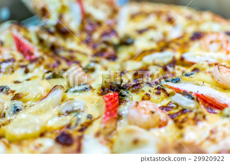 Pizza served on wooden circle board Pizza served on wooden circle board 29920922