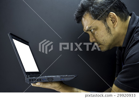 Asia man serious look at computer notebook 29920933