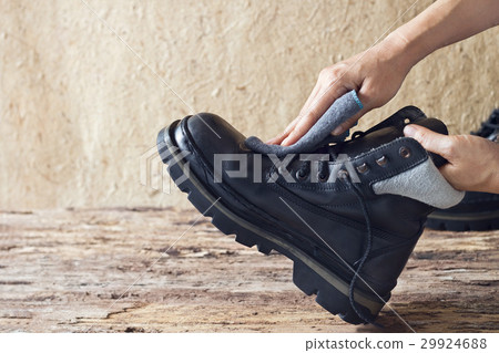 Cleaning shoes on wooden background Cleaning shoes on wooden background 29924688