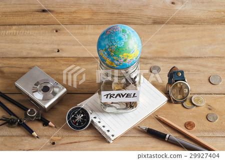 Savings money in glass jar on wood for travelling Savings money in glass jar on wood for travelling 29927404