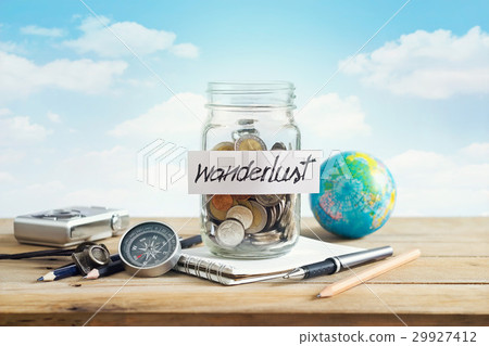 Savings money in glass jar on blue sky for travel Savings money in glass jar on blue sky for travel 29927412