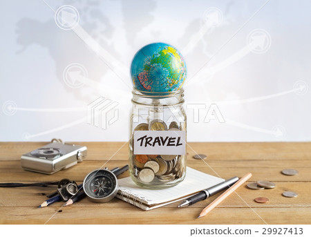 Savings money in glass jar on world map for travel Savings money in glass jar on world map for travel 29927413