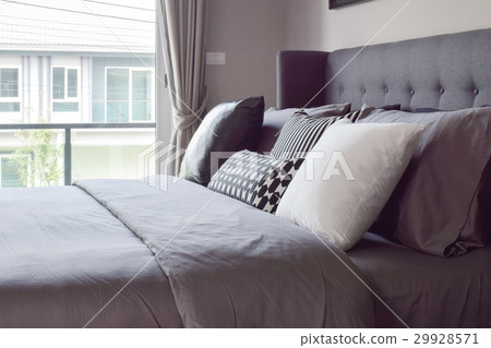 Classic bedroom with pillows next to the window Classic bedroom with pillows next to the window 29928571