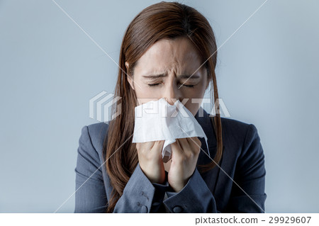 Woman blowing her nose 29929607