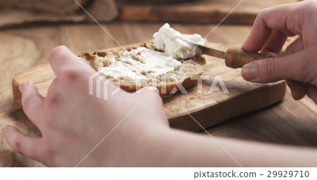 rustic bread with ricotta cheese on wood board 29929710