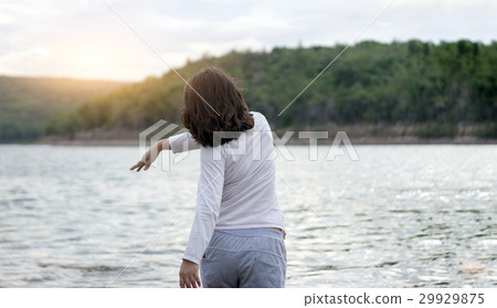 asian woman trow rock to river 29929875