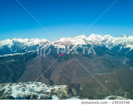 Paraglider flies over the mountains over the ski Paraglider flies over the mountains over the ski 29930596