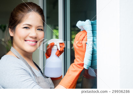 asian housewife cleaning on window glass asian housewife cleaning on window glass 29936286