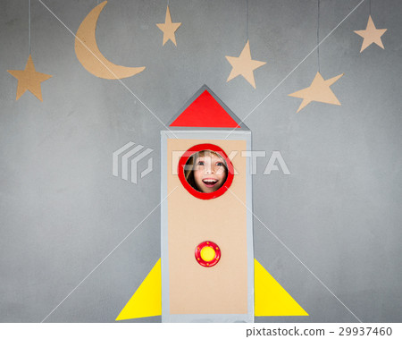 Kid playing with cardboard rocket at home Kid playing with cardboard rocket at home 29937460
