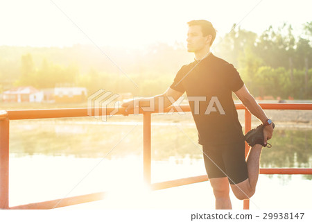 Fitness man stretching his leg before a run 29938147