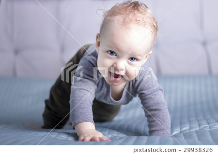 Crawling baby boy looking at camera. Smiling 29938326