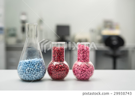 Multicolored pills in glass flasks 29938743
