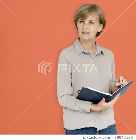 Mature Caucasian Woman Smiling Holding Notebook Mature Caucasian Woman Smiling Holding Notebook 29943189