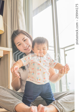 Happy mother holding adorable child baby boy.. Happy mother holding adorable child baby boy.. 29944175