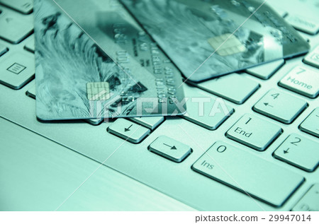 Credit cards on a laptop keyboard Credit cards on a laptop keyboard 29947014