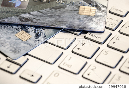Credit cards on a laptop keyboard Credit cards on a laptop keyboard 29947016