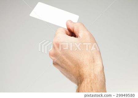Male hand holds white card over gray 29949580
