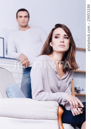 Attractive cheerless woman sitting in the armchair 29953286
