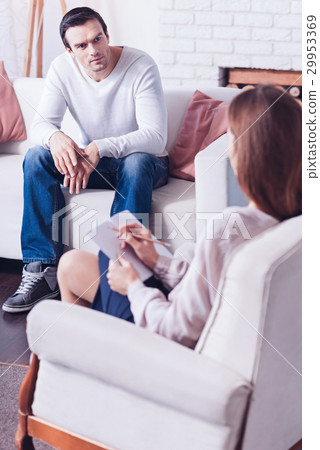 Pleasant nice man looking at his therapist 29953369