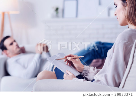 Confident professional psychologist taking notes Confident professional psychologist taking notes 29953371
