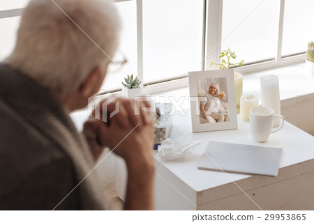 Selective focus of a photo standing on the bedside 29953865